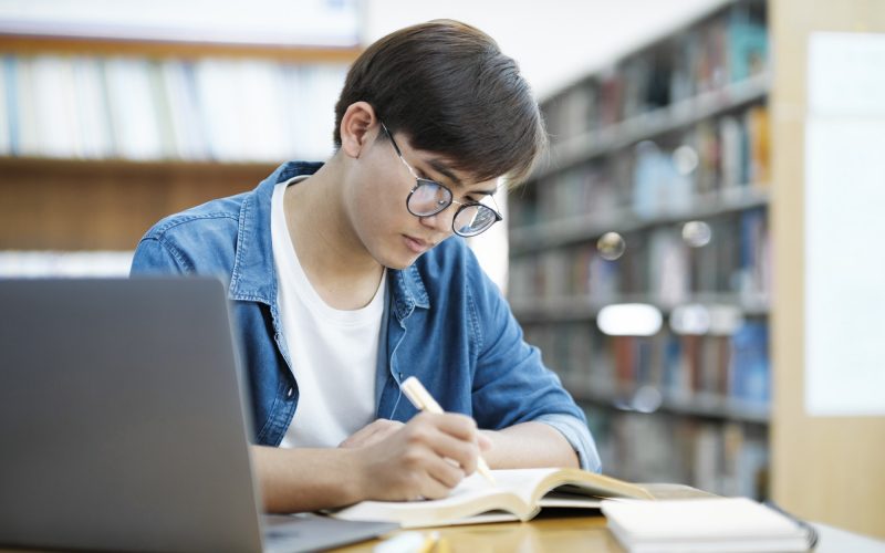 Student studying at library.