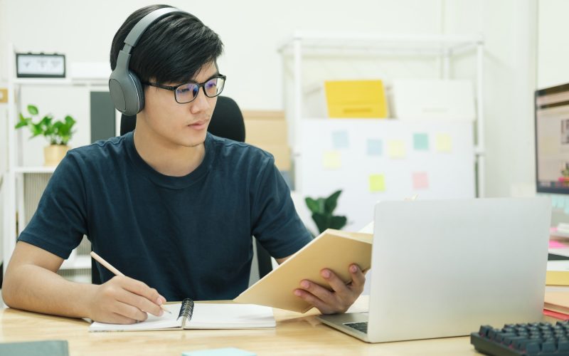 Young man study in front of the laptop computer at home